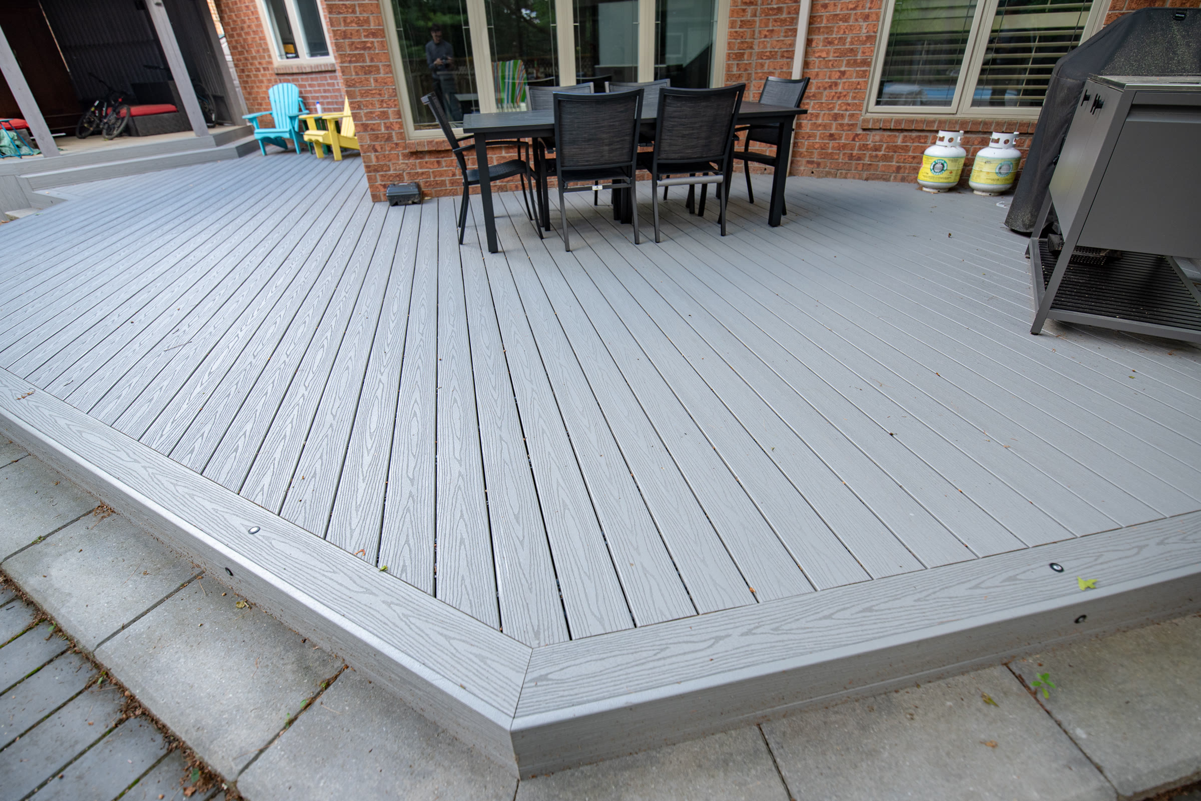 Close view of solid composite deck boards with a clean mitred picture-frame border
