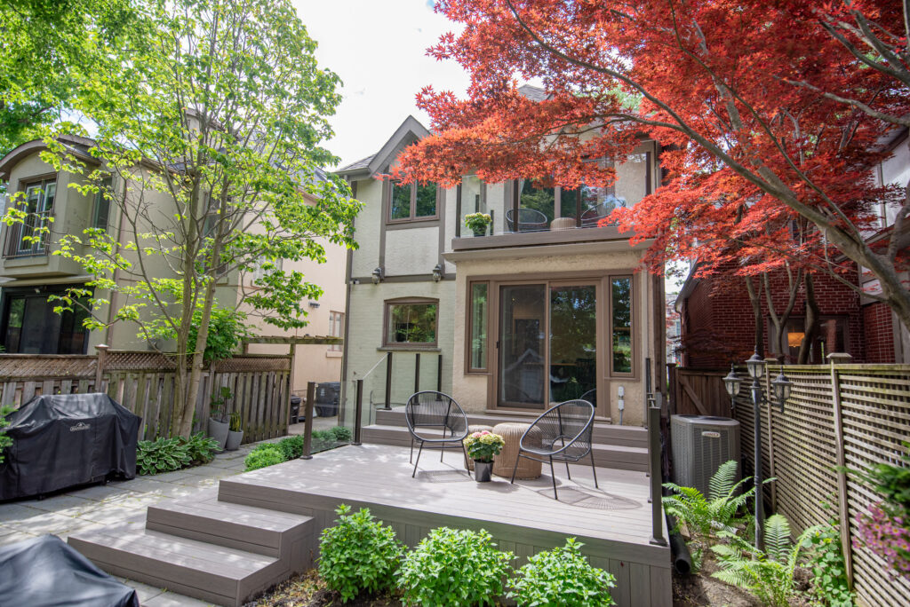 Completed backyard composite deck with black aluminum railings