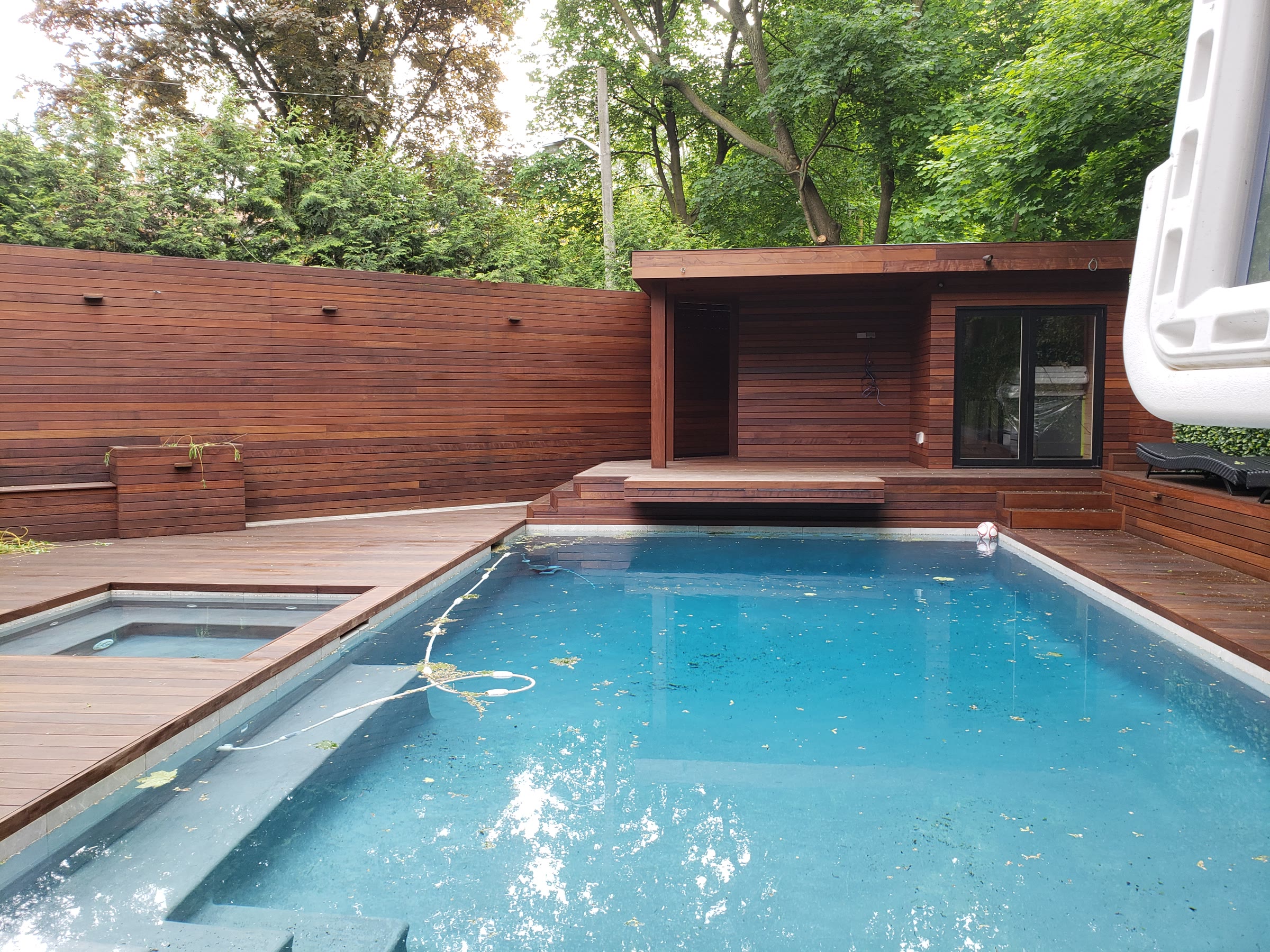Finished Ipe pool deck with steps beside a residential swimming pool