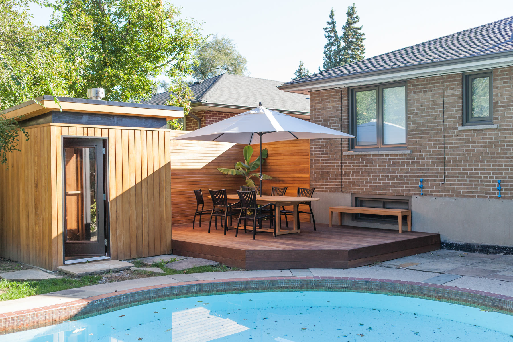 Backyard pool deck project Completed backyard pool deck with wood-look decking and black aluminum railings