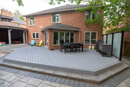 Completed Richmond Hill composite deck with dining space, existing gazebo and frosted glass privacy screen